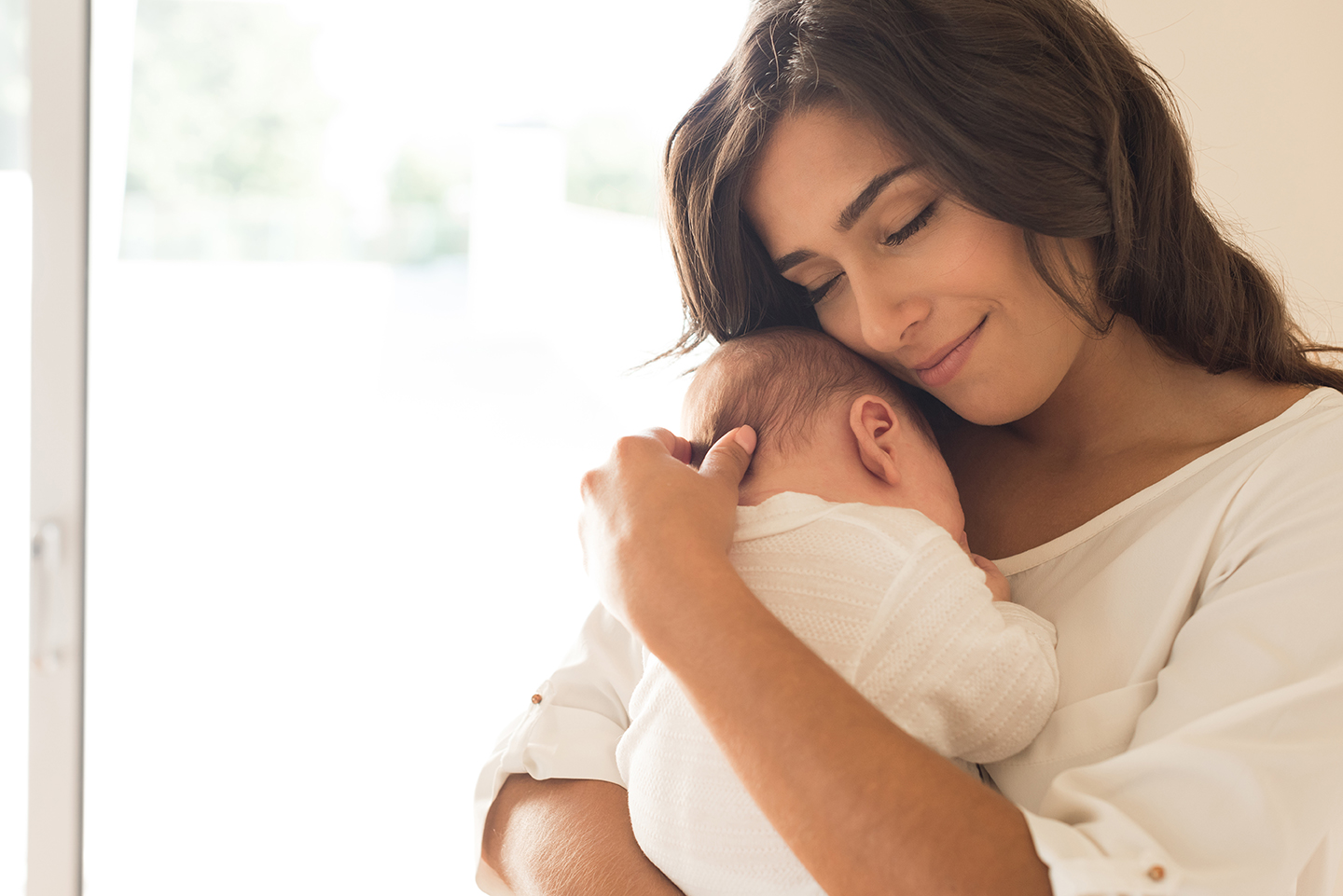 Woman with newborn baby. 